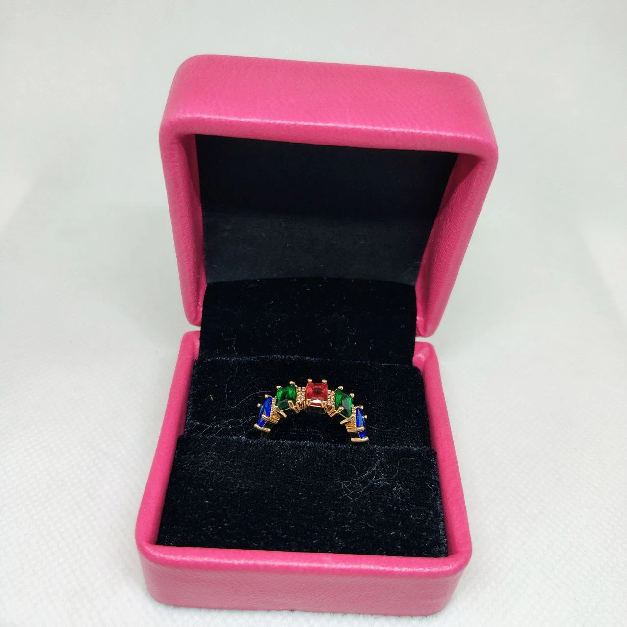 vibrant gold ring adorned with colorful gemstones,