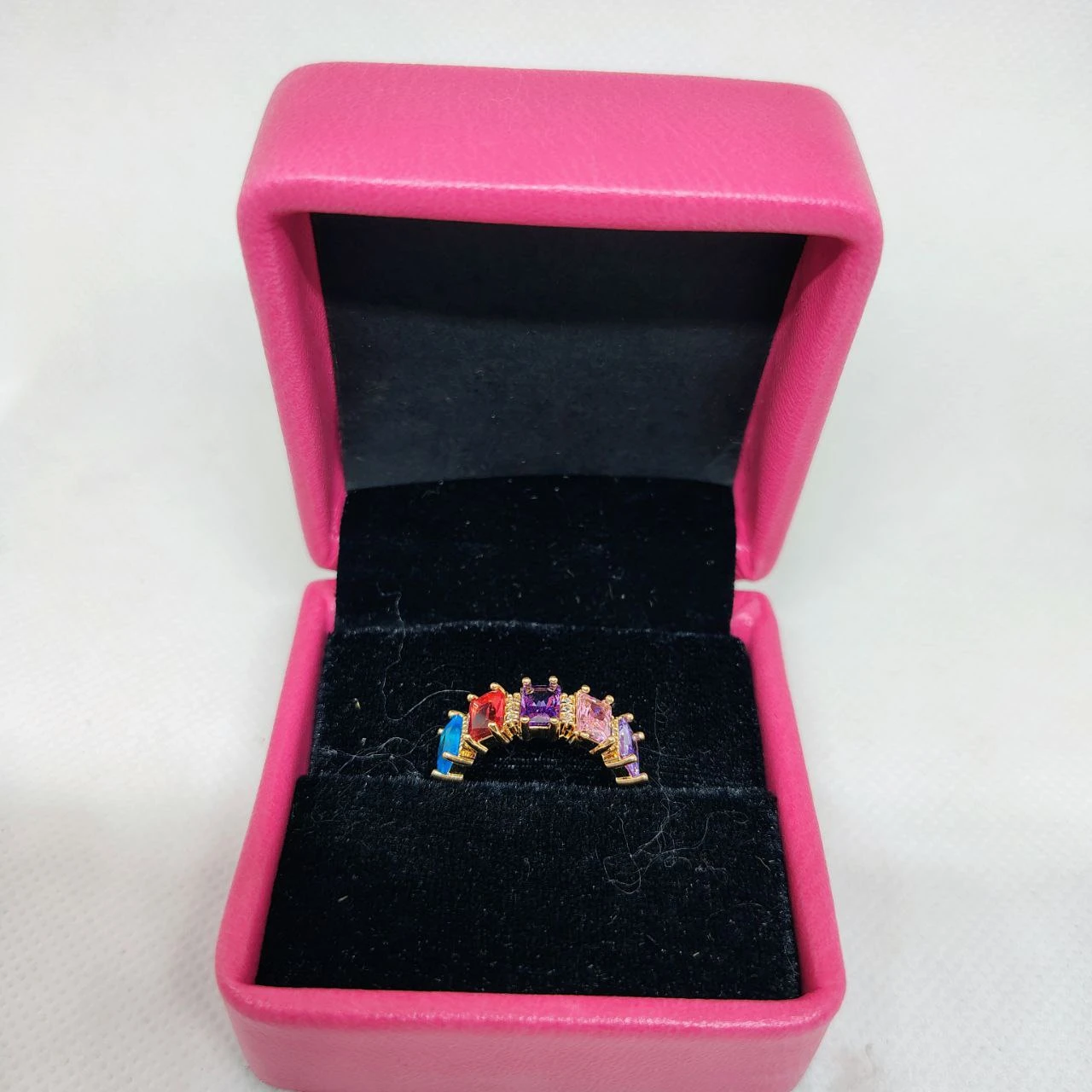 vibrant gold ring adorned with colorful gemstones,